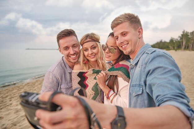 Close up on young friends having fun on the beach