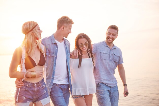 Close up on young friends having fun on the beach