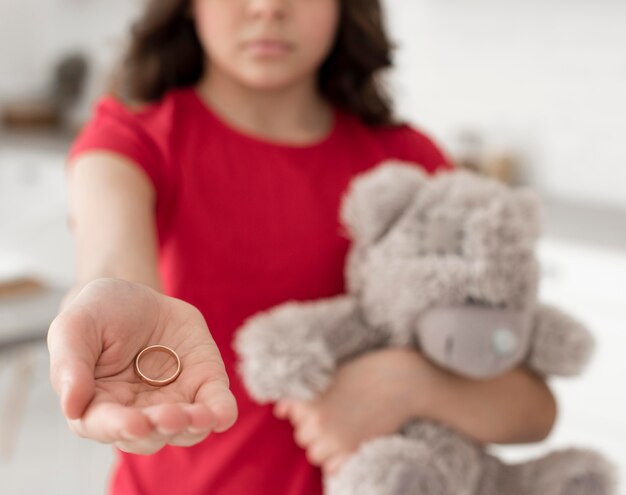 Close-up young girl holding wedding ring