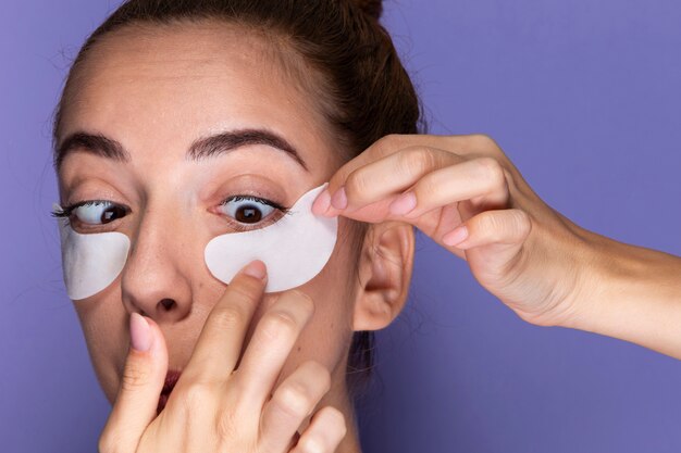 Close-up young girl with eye pads on