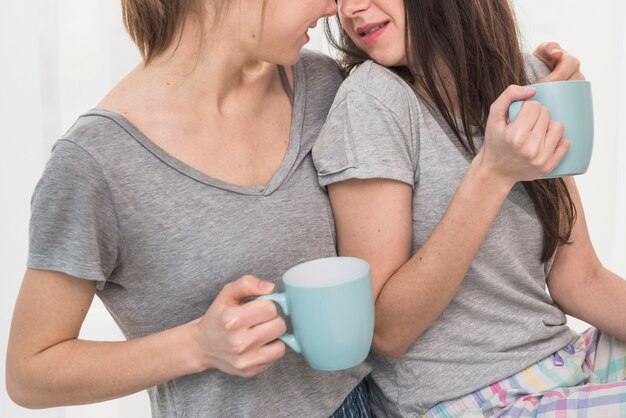 Close-up of young lesbian couple drinking the coffee