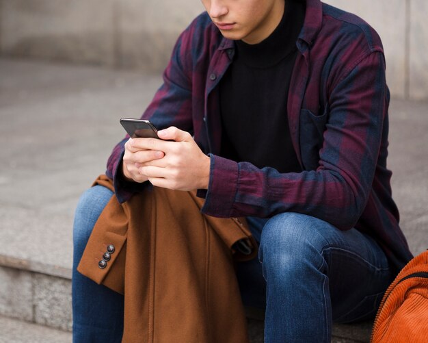 Close-up young man browsing his phone