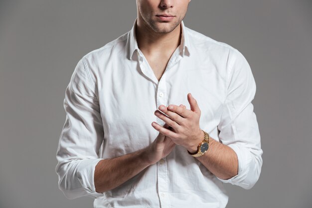 Close up of a young man dressed in white shirt