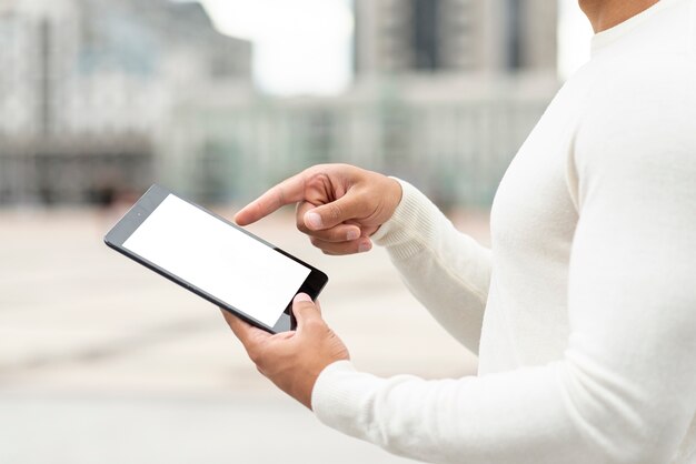 Close-up young man holding a tablet