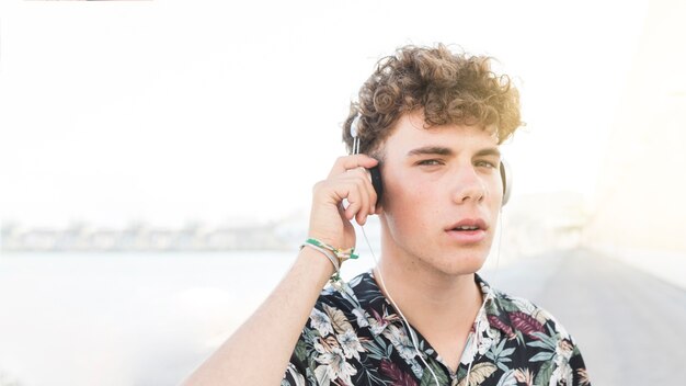 Close-up of a young man listening to music on headphone