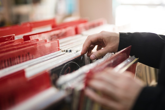 Close-up young man looking for vinyls in store