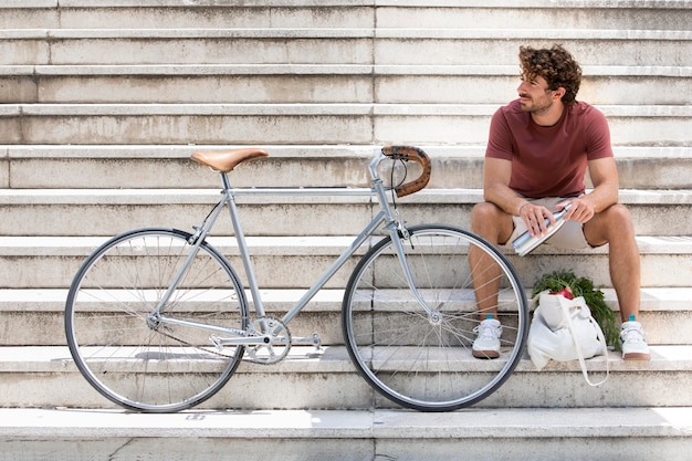 Close up on young man taking a break after shopping