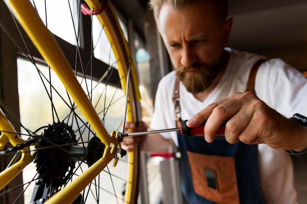 Close up on young man working on a bike