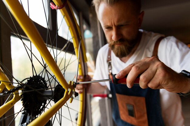 自転車に取り組んでいる若い男にクローズアップ