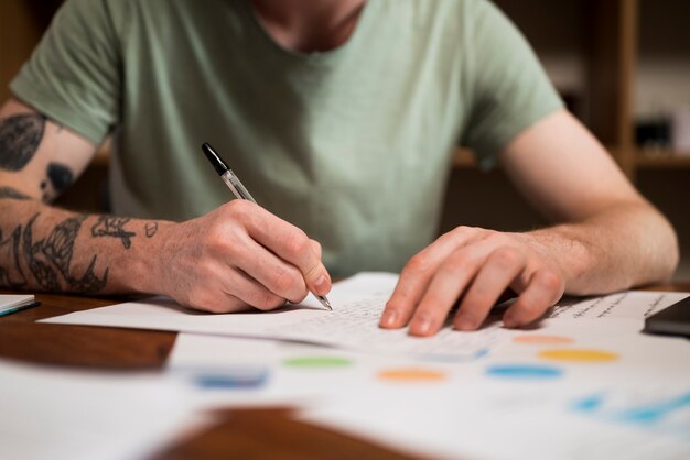 Close up on young man writing in a virtual classroom