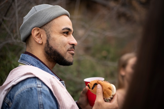 Free photo close up on young person at a barbeque