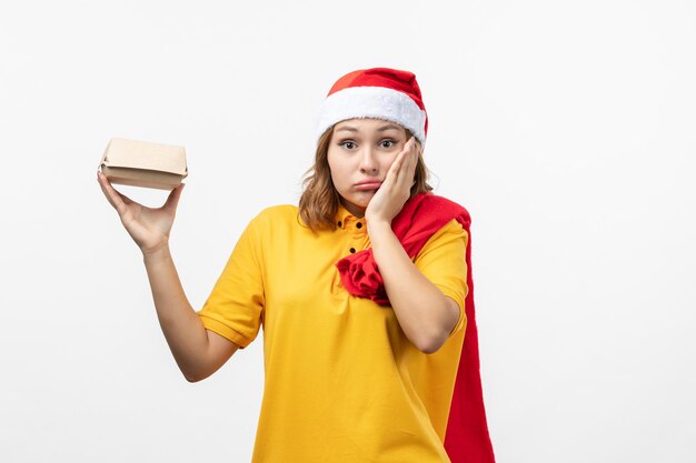 Close up on young pretty woman wearing Christmas hat isolated