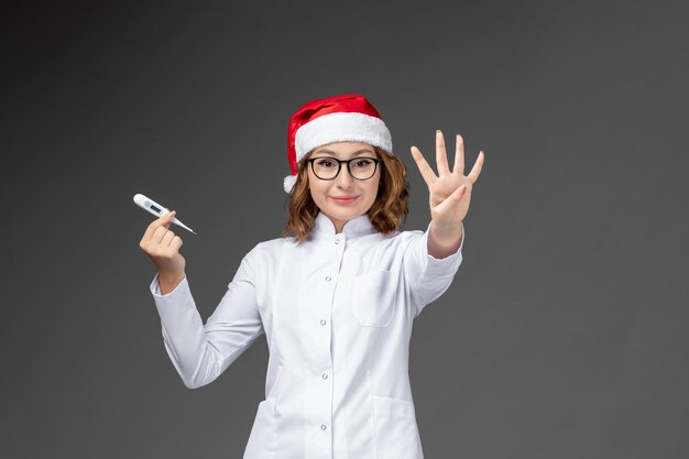 Close up on young pretty woman wearing Christmas hat isolated