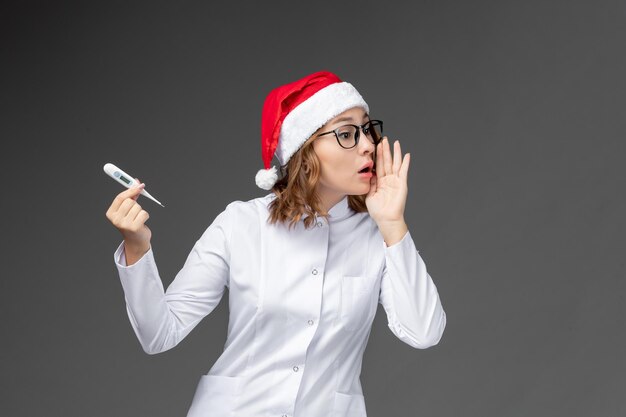 孤立したクリスマス帽子をかぶって若いきれいな女性にクローズアップ