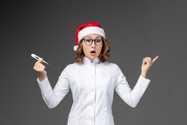 Close up on young pretty woman wearing Christmas hat isolated