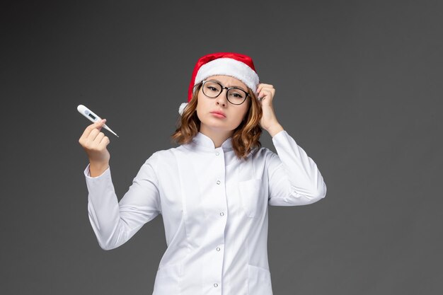 Close up on young pretty woman wearing Christmas hat isolated