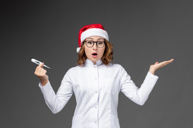 Close up on young pretty woman wearing Christmas hat isolated