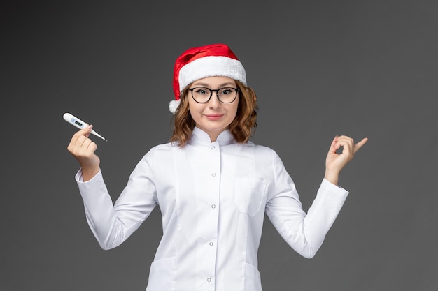 Close up on young pretty woman wearing Christmas hat isolated