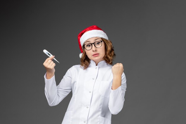 Close up on young pretty woman wearing Christmas hat isolated