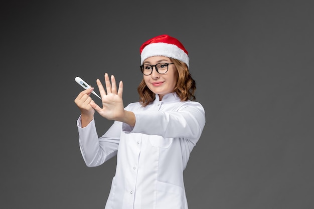 Close up on young pretty woman wearing Christmas hat isolated