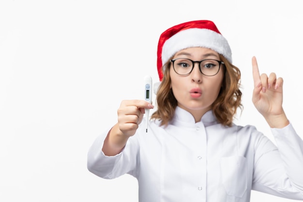 Close up on young pretty woman wearing Christmas hat isolated