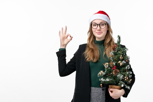 Close up on young pretty woman wearing Christmas hat isolated