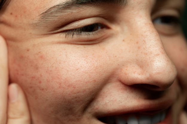 Close up young smiley man skin texture