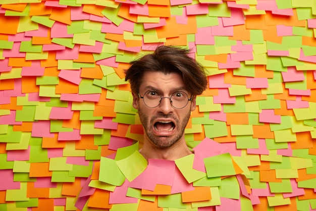 Free photo close up on young student surrounded by sticky notes