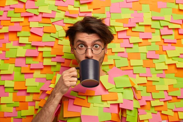 Free photo close up on young student surrounded by sticky notes