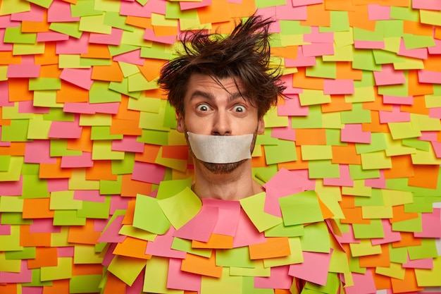 Free photo close up on young student surrounded by sticky notes