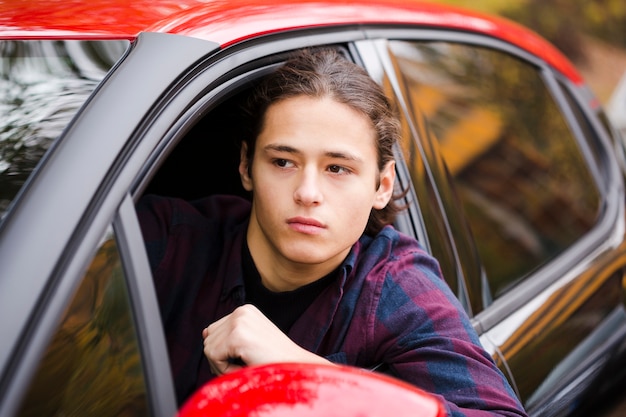 Close-up young tourist driving a car