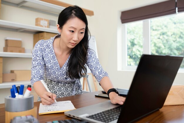 Close up on young woman checking informations on laptop