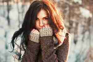 Free photo close-up of young woman covering her mouth with her fists