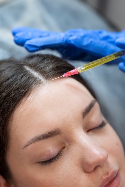 Close up young woman getting prp injection