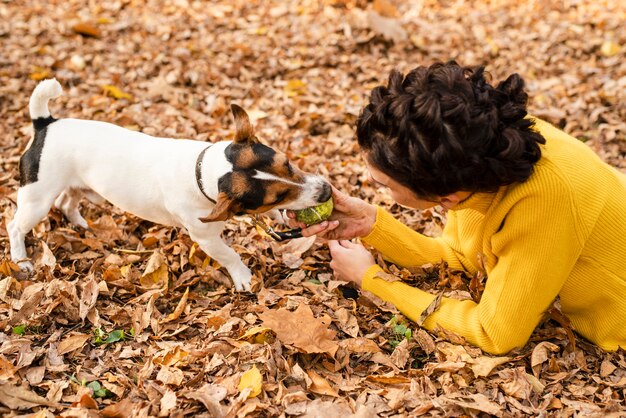 彼女の犬と遊ぶ若い女性をクローズアップ