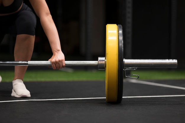 Free photo close-up young woman training with weightlifting