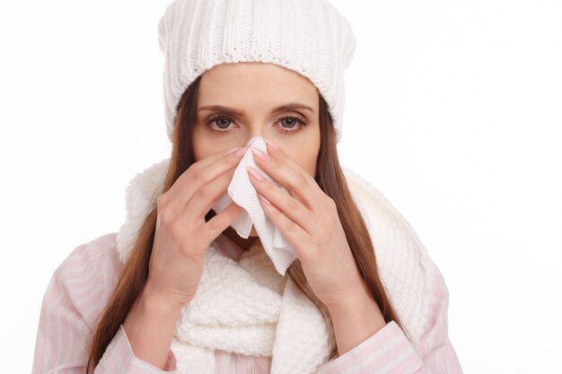 Close-up of young woman using a tissue