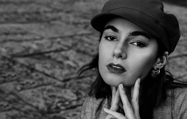 Free Photo close-up of a young woman with finger on chin looking at camera