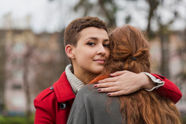 Close-up young women hugging each other