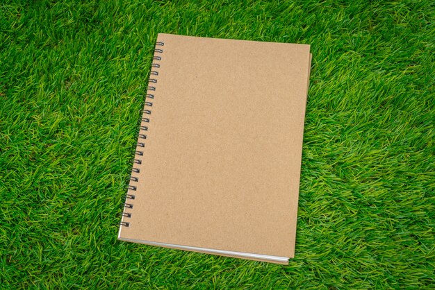 Closed notebook on grass
