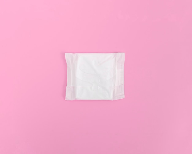 Closed sanitary towel on pink background