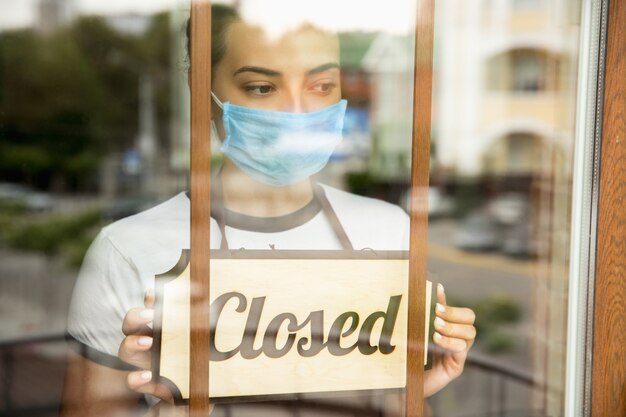 Closed sign on the glass of street cafe or restaurant