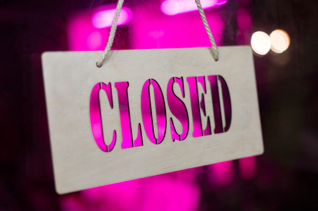 Closed sign with bright purple light