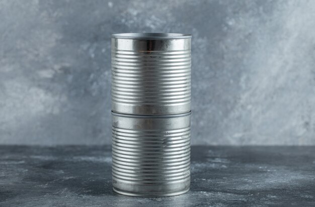 Closed tin cans placed on marble.