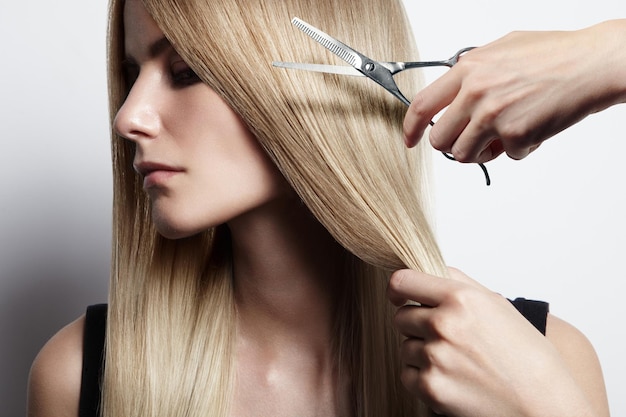 Closeiup portrait of a woman with a hand holding scissors