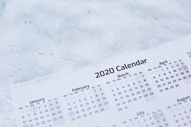 Closeup of a 2020 calendar on a white textured surface