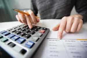 Free photo closeup of accountant hands counting on calculator