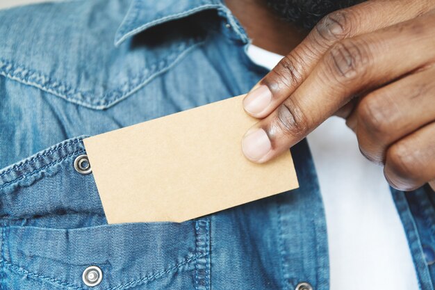 Closeup of African man’s hands holding business card