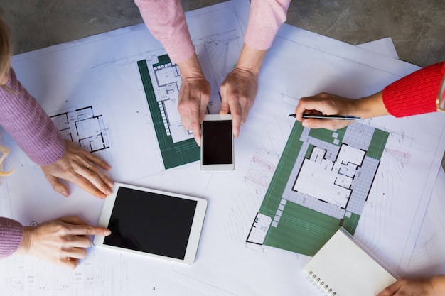 Closeup of architects working with drawings at desk