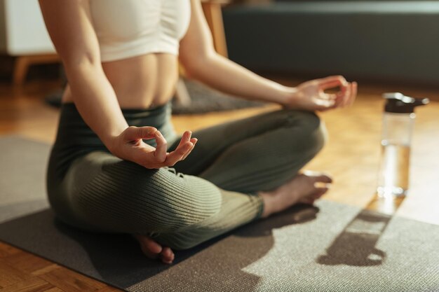 Closeup of athletic woman practicing Yoga in lotus position